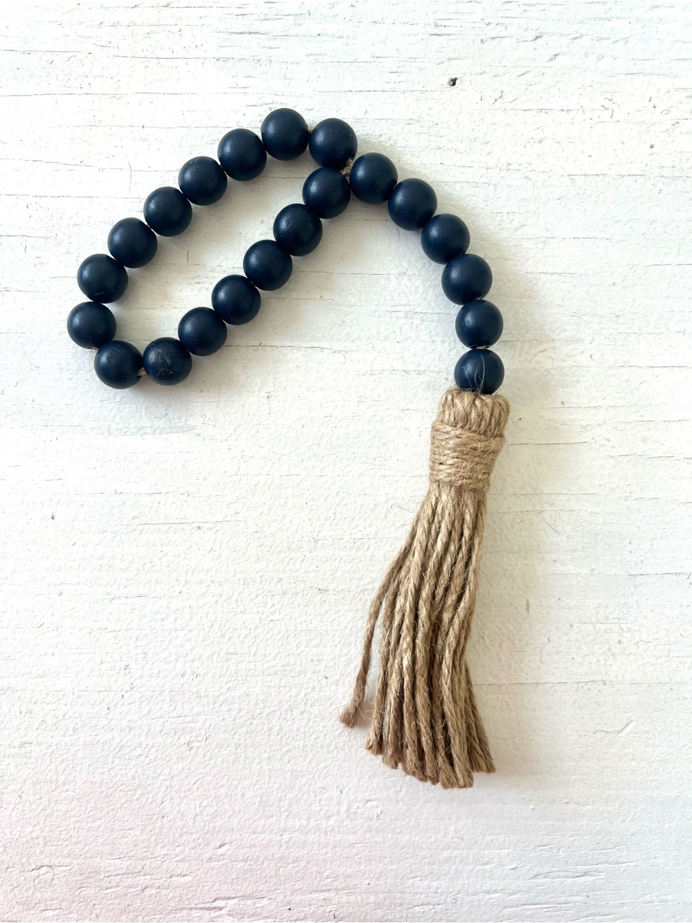 navy blue wooden bead garland accented with a rustic jute tassel